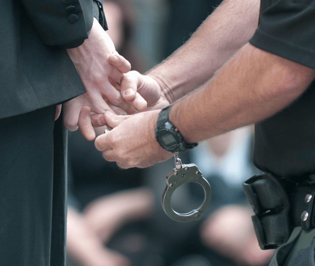 Someone being handcuffed by the police.