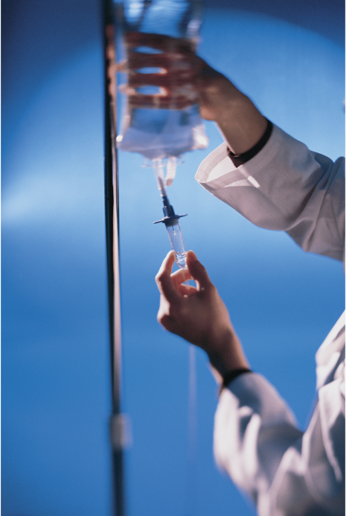 A pharmacist checks an IV bag.