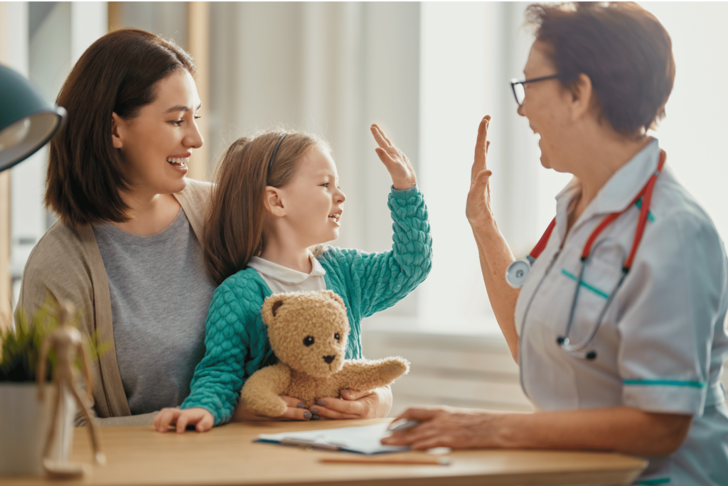 Nurse and child-patient high five.