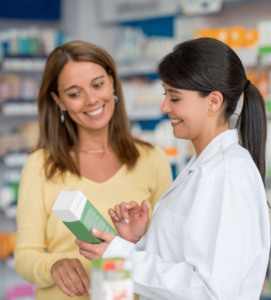 A pharmacy technician helps a customer find the correct product