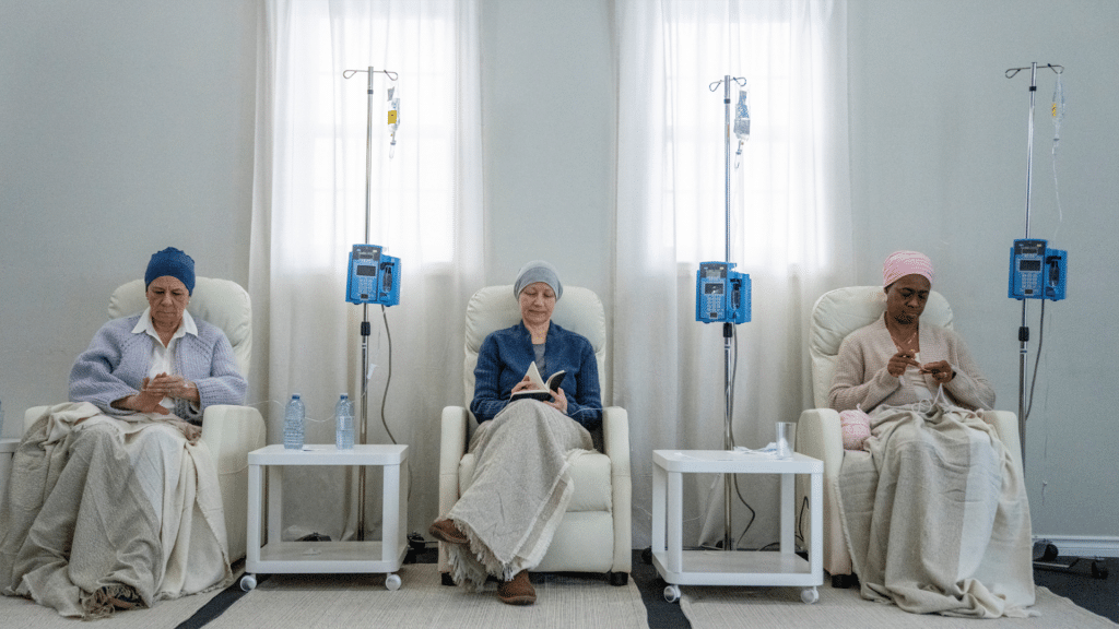 Three women receive a chemotherapy IV treatment.