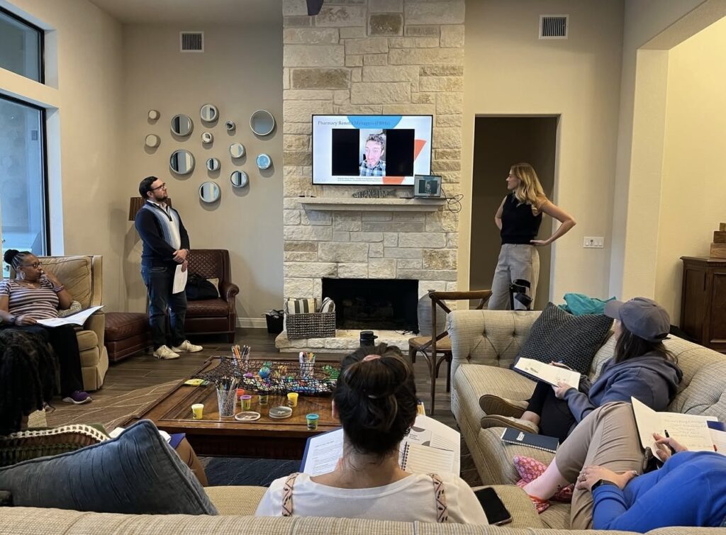 Patient advocates engage in an advocacy lesson led by Kindyl Boyer (Director of Advocacy) and Sam Miller (Advocacy Associate) during a retreat, learning about pharmacy benefit managers and healthcare access barriers.