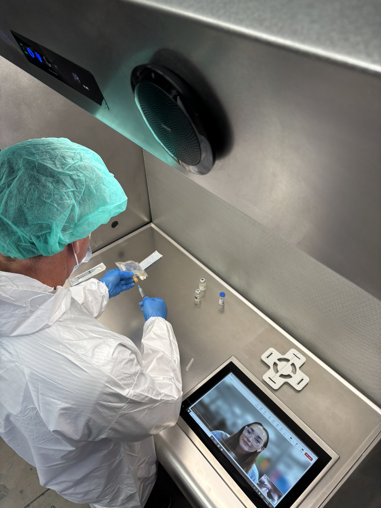 A pharmacist using a Germfree Smarthood™ to mix a medication.