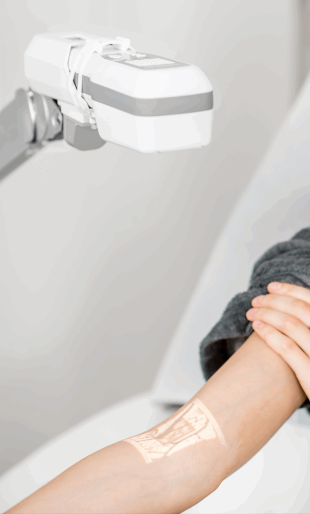 A patient using a tabletop vein finder.