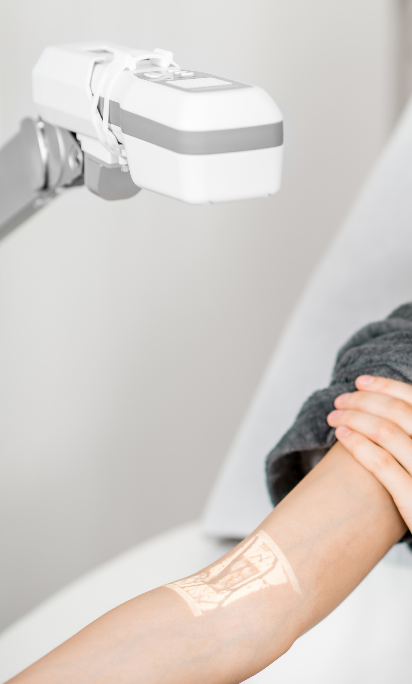 A patient using a tabletop vein finder.
