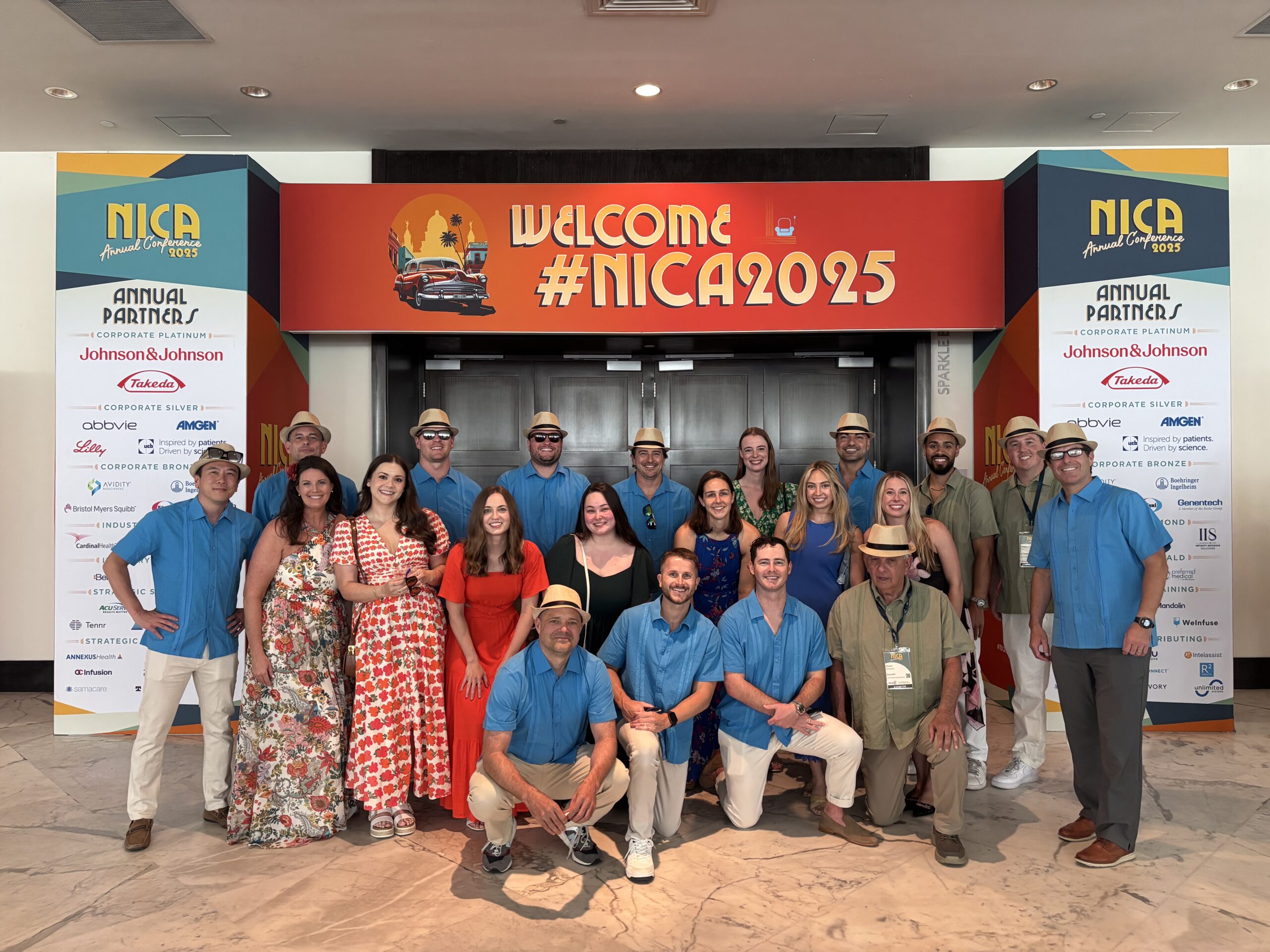 The WeInfuse & RxToolKit teams pose for a picture in front of the 2025 NICA Conference entrance before the IAF TOAST: Together for Treatment gala.