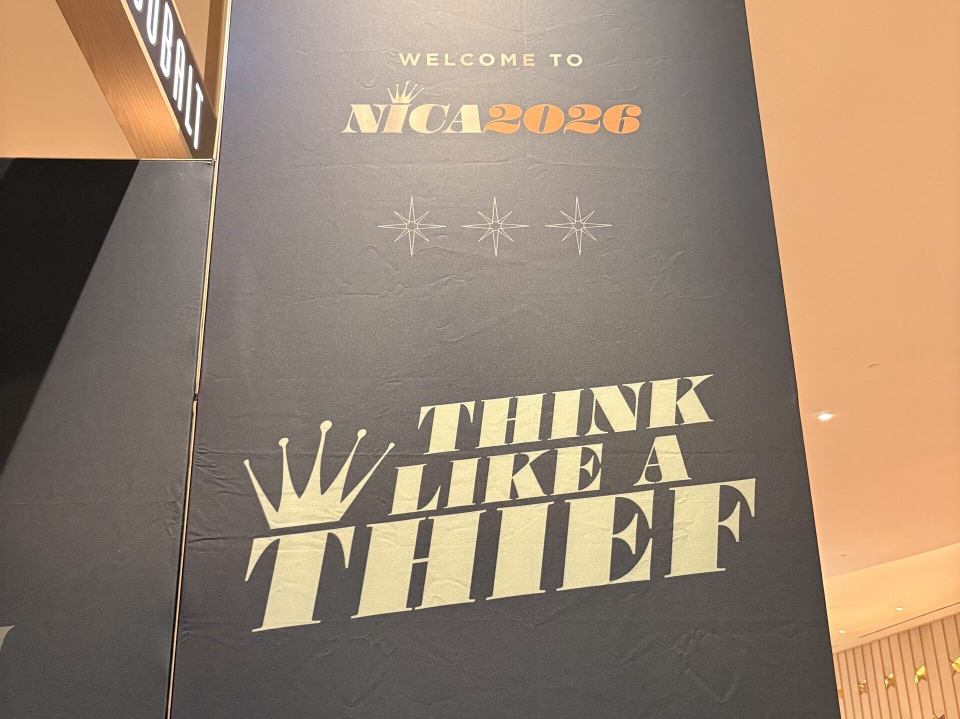 The wall to the entryway into the NICA exhibit hall, with "Think Like a Thief" written on it.