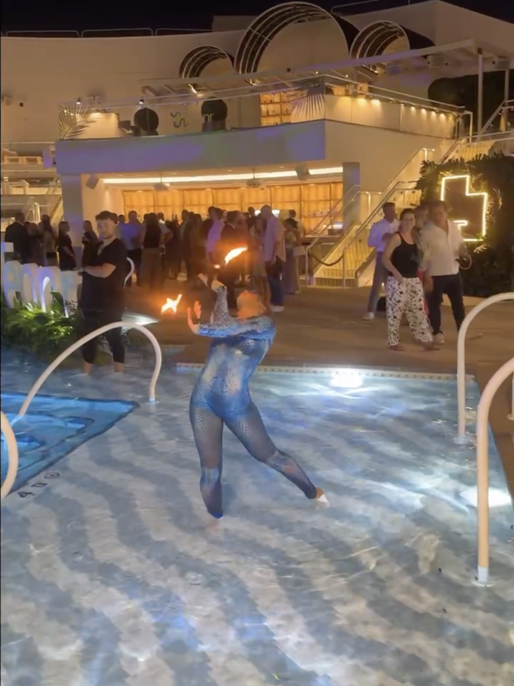 A women swings fire around.